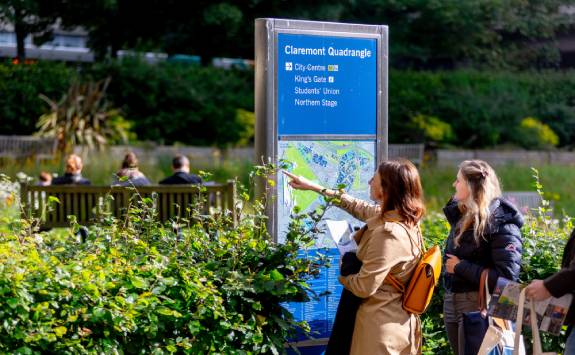 Two people looking at a map on Newcastle campus.